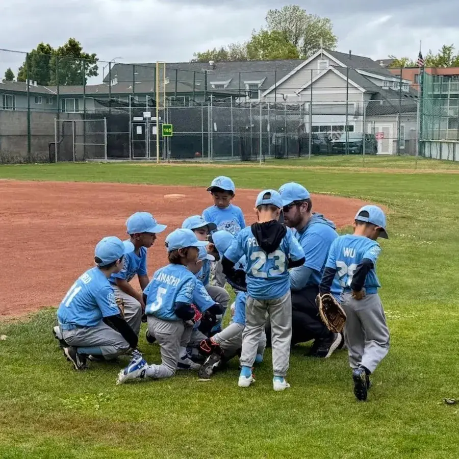 SMNLL players huddled with their coach